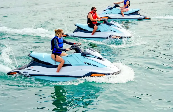 Jet ski riders crossing the water together near North Ave Beach.