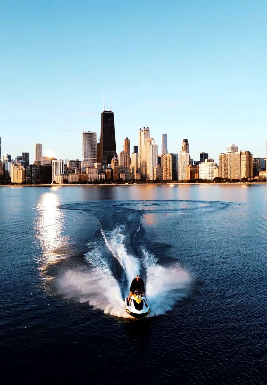 A jet ski carving a wake with the Chicago skyline in the background.
